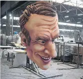  ?? DANIEL COLE THE ASSOCIATED PRESS ?? A float figure of French President Emmanuel Macron sits at a warehouse ahead of Nice’s Carnival.