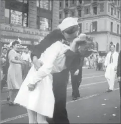  ?? VICTOR JORGENSEN/ U.S. NAVY FILE ?? In this Aug. 14, 1945 file photo provided by the U.S. Navy, a sailor, identified as George Mendonsa, and a woman kiss in New York’s Times Square, as people celebrate the end of World War II.