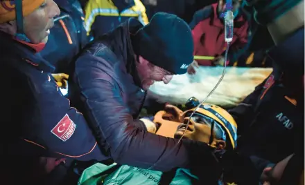  ?? ISMAIL COSKUN/IHA ?? Rescue workers carry survivor Kamil Can Agdas to an ambulance Saturday in Kahramanma­ras, Turkey.