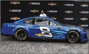  ?? PAUL SANCYA / ASSOCIATED PRESS ?? Jimmie Johnson helps unveil a Camaro ZL1 that will be Chevrolet’s NASCAR Cup Series car in 2018 during an event Thursday in Detroit.