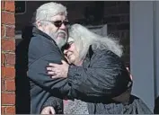 ?? Steve Helber Associated Press ?? SUSAN BRO, the mother of Heather Heyer, who was killed in Charlottes­ville, Va., embraces her husband.