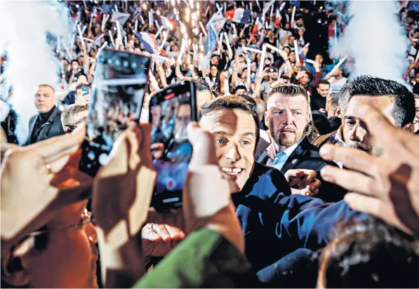  ?? ?? Emmanuel Macron, the French president, shook hands with supporters as he arrived for yesterday’s rally at La Defense Arena