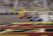  ?? JOHN LOCHER — THE ASSOCIATED PRESS ?? Martin Truex Jr. (19) and Kyle Larson (5) drive during a NASCAR Cup Series race Sunday in Las Vegas.