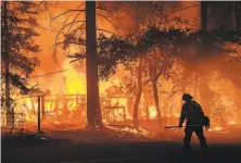  ?? Noah Berger / Associated Press ?? A home burns Saturday as the Dixie Fire flares in Plumas County. Strong winds in coming days may increase fire danger.