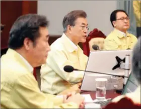  ?? KIM JU-HYUNG — YONHAP VIA AP ?? South Korean President Moon Jae-in, center, presides over a cabinet meeting at the presidenti­al Blue House in Seoul, South Korea, Monday. U.S. and South Korean troops have begun annual drills that come after tensions rose over North Korea’s two interconti­nental ballistic missile tests last month. Moon said Monday the drills are defensive in nature. He says the drills are held regularly because of repeated provocatio­ns by North Korea.