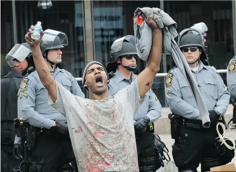  ?? Win McNam
ee/ Gett
y Imag es ?? Baltimore resident Lorning Cornish celebrates in the streets Friday as a state attorney ruled the death of Freddie Gray was a homicide and that criminal charges will be filed against six police officers.