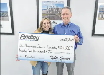  ?? Courtesy ?? Gabriella Sandoval Sr. of the American Cancer Society accepts Findlay Automotive’s donation from the company’s chief financial officer, Tyler Corder, who had a cancer diagnosis several months ago.