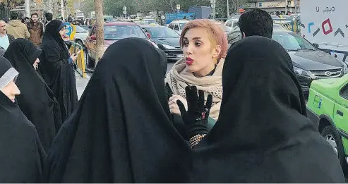  ?? TWITTER ?? A photo posted to Twitter Wednesday shows a woman without a hijab being confronted by Iran’s “morality police.” “Today is #whitewedne­sday it is a day we practice our civil disobedien­ce. Removing hijab. these women warning me to put my hijab on I peacefully define my right.”
