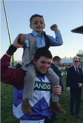  ??  ?? Derek Fox celebrates his famous victory in the Grand National with terminally ill youngster, Bradley Lowery.