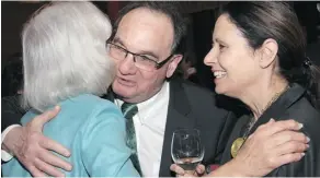  ??  ?? Supreme Court of Canada Chief Justice Beverley McLachlin gets a hug from her colleague, Justice Michael J. Moldaver, joined by his wife, Riky, at the reception at Ottawa City Hall.