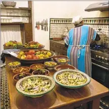  ?? Bob Drogin Los Angeles Times ?? A COOK prepares dinner in the kitchen at Dar Seffarine, a traditiona­l guest house in the ancient walled city of Fez, Morocco.
