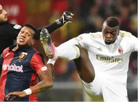  ??  ?? GENOVA: AC Milan’s forward from France M’Baye Niang (R) fights for the ball with Genoa’s midfielder from Brazil Andrade Edenilson during the Italian Serie A football match Genoa vs AC Milan at “Luigi Ferraris” Stadium in Genova on Tuesday. —AFP