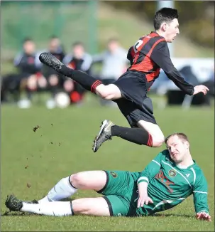  ?? Picture: Ken Finegan ?? Kentstown Rovers’ Paul Sweeney’s challenge sends Tadhg O’Connor (Bellurgan United) airborne during Sunday’s Tully Bookmakers Cup tie, which ended 2-0 to the Peninsula side.