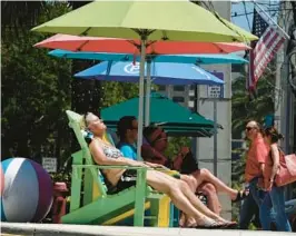  ?? JOE CAVARETTA/SOUTH FLORIDA SUN SENTINEL ?? A woman sunbathes in Lauderdale-by-the-Sea on Tuesday. High temperatur­es for the rest of the week should be in the low 80s. Low temperatur­es are forecast for the upper 60s and low 70s.