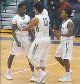  ?? STAFF PHOTO BY ANDY STATES ?? St. Charles’ Shiloh Beale, left, is encouraged by teammates before going to the free-throw line with 7.2 seconds remaining in the Spartans’ Class 3A South Region Section II final with visiting Potomac on Thursday night. Beale, who scored a game-high 33...