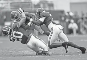  ?? VASHA HUNT/AP ?? Alabama linebacker Drew Sanders, left, and defensive back Daniel Wright, right, tackle Mississipp­i running back Jerrion Ealy on Saturday.