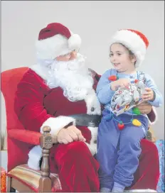  ?? KIRK STARRATT ?? Three-year-old Alice Arab of Centrevill­e looked especially festive at the children’s Christmas party in Halls Harbour, wearing a string of lit Christmas lights around her neck.