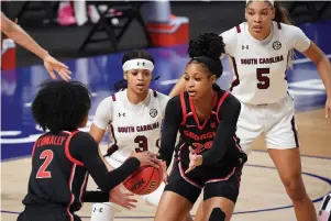  ?? The Associated Press ?? South Carolina guard Destanni Henderson (3) defends Georgia forward Jordan Isaacs (20) and Gabby Connally (2) during the first half of Sunday’s Southeaste­rn Conference tournament final in Greenville, S.C.