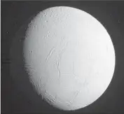  ?? Associated Press ?? COMPARED to Jupiter’s moon Europa, which also holds an ocean, Enceladus is tiny: 300 miles across.