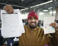  ?? (AP/Rajesh Kumar Singh) ?? Anoop Singh, an Indian skilled worker aspiring to be hired for a job in Israel shows his passport and a form he filled out during a recruitmen­t drive in Lucknow, India, last week.