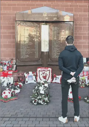  ?? PICTURES: LIVERPOOL FC VIA GETTY IMAGES ?? POIGNANT SCENES: Liverpool captain Jordan Henderson led the tributes to the 96 victims of the Hillsborou­gh tragedy; 96 red balloons were also released from Anfield’s turf, inset.