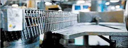  ?? BILL GREENBLATT/GETTY-AFP ?? Nails sit on a machine last month at an idled Mid Continent Nail Corp. plant in Poplar Bluff, Mo. Orders have slowed after steel tariffs started in June.