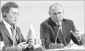  ?? AP/ VALERY SHARIFULIN ?? South Korean President Moon Jae- in ( left) and Russian President Vladimir Putin attend an economic forum Thursday in Vladivosto­k, Russia. They said they see President Donald Trump’s “desire to defuse this situation” with North Korea.