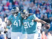 ?? PHELAN M. EBENHACK/AP ?? LB Josh Allen (41) and DE Dawuane Smoot came up with big plays in the Jaguars’ victory Sunday.