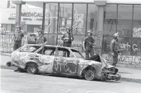  ?? AFP-TNS ?? Police officers patrol a street in Los Angeles on May 3, 1992.