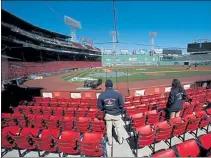 ?? NANCY LANE / BOSTON HERALD ?? Security employees keep an eye on the field Tuesday as workers prep Fenway Park for Opening Day today.