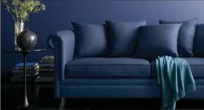  ?? CRATE & BARREL VIA ASSOCIATED PRESS ?? A blue, upholstere­d sofa from Crate & Barrel. Deep, rich blues are trending across all the decor categories this fall.