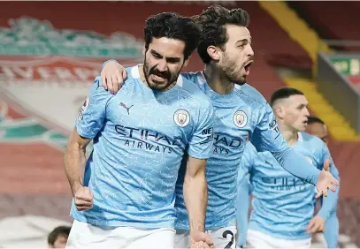  ?? Piture: AFP ?? STRIKE FORCE. Manchester City’s Ilkay Gundogan (left) celebrates with team-mate Bernardo Silva after scoring a goal during their English Premier League match against Liverpool at Anfield last night.