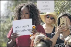  ?? GREGORY BULL / AP ?? People protest at the El Cajon Police Department in California on Wednesday. A black man reportedly acting erraticall­y was shot and killed Tuesday by police after pulling an object from his pocket.