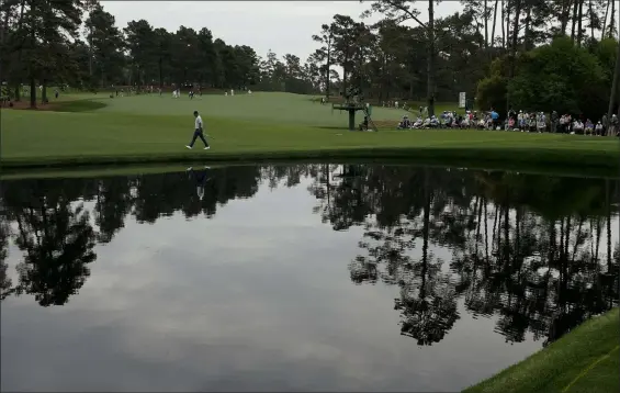  ?? Charlie Riedel The Associated Press ?? Justin Rose, of England, walks to the 16th green Thursday during the first round of the Masters in Augusta, Ga. He leads by four strokes after the first round.