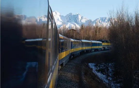  ??  ?? RIDING THE RAILS: A train rolls through the Alaskan wilderness, offering riders the chance to relax and enjoy the state’s dramatic scenery.