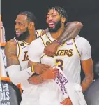  ?? MARK J. TERRILL/ASSOCIATED PRESS FILE PHOTO ?? The Lakers’ LeBron James, rear, and Anthony Davis celebrate after defeating the Heat for the NBA title Oct. 11 in Lake Buena Vista, Fla. Davis signed a five-year contract worth up to $190 million to return to Los Angeles.