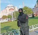  ??  ?? Turkish police officer patrols the area by the Byzantine-era Hagia Sophia, one of Istanbul’s main tourist attraction­s in Istanbul.