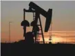  ??  ?? A pump jack operates at sunset in an oil field in Midland, Texas.