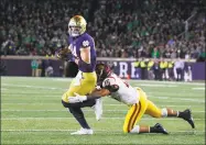  ?? Paul Sancya / Associated Press ?? Notre Dame tight end Cole Kmet (84) breaks the tackle of Southern California safety Talanoa Hufanga on his way to a touchdown in the first half on Saturday in South Bend, Ind.