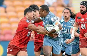  ?? GETTY IMAGES ?? Manasa Mataele tries to fend off a Sunwolves tackler during Saturday’s match in Brisbane.