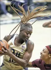  ?? Keith Srakocic/Associated Press ?? Pitt’s Yacine Diop, left, pulls down a rebound in front of Florida State’s Nicole Ekhomu.