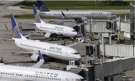  ?? AP FILE PIC ?? United Airlines planes parked at George Bush Interconti­nental Airport in Houston. The airline says it will reduce overbookin­g flights and improve customer satisfacti­on.