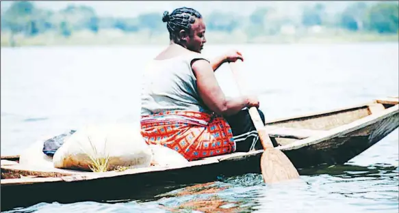  ?? PHOTO: LUCY LADIDI ATEKO ?? DIGNITY OF LABOUR! A female transporte­r ferrying food items from Dnakopa Village to Kupa Village, via Suleja Dam in Niger State … yesterday