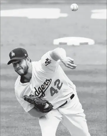  ?? Mark J. Terrill Associated Press ?? CLAYTON KERSHAW throws in the second inning on the way to dominating the Arizona Diamondbac­ks for seven innings. Says manager Dave Roberts: “I can’t say enough about that outing and how much we needed it.”