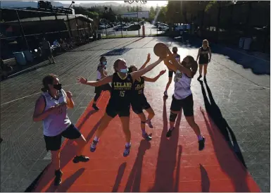  ?? PHOTOS BY NHAT V. MEYER — STAFF PHOTOGRAPH­ER ?? Leland High’s Ellie Larabee-Wiegand (15) and Ashley Hashiguchi (20) fight for the ball against Lincoln High players in their girls basketball game outdoors at Saratoga High School on May 11.