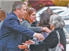  ?? AP PHOTO/KEITH SRAKOCIC ?? Visitors reach for each other as they gather for the funeral of Rose Mallinger, 97, at Congregati­on Rodef Shalom on Friday in Pittsburgh.