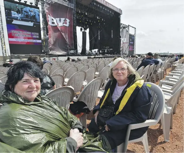  ?? ED KAISER ?? Jackie Hunt, left, of Red Deer and Kathleen Zimmerman of Winfield were not too pleased about the seat changes due to the altered stage setup on Friday at Big Valley Jamboree in Camrose. The new layout is designed to encourage more audience...