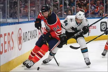  ?? JASON FRANSON – THE CANADIAN PRESS VIA AP ?? The Sharks’ Maxim Letunov, right, and William Lagesson of the Oilers vie for the puck in the first period Thursday night. Letunov’s second-period goal gave San Jose a 3-2 lead.