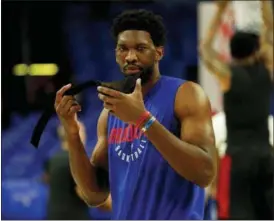  ?? CHRIS SZAGOLA — THE ASSOCIATED PRESS ?? Philadelph­ia 76ers’ Joel Embiid, of Cameroon, about to put his mask back on prior to the first half in Game 1 of a first-round NBA basketball playoff series against the Miami Heat, Saturday.