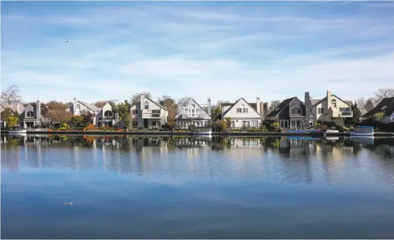  ?? Gabrielle Lurie / The Chronicle ?? The view from Foster City’s Cooking Papa restaurant shows homes on an inlet. Built on landfill, Foster City is at risk from sea level rise and sinking shoreline.